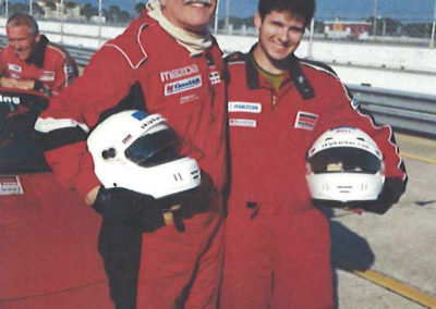 Photo of Lee with Will in racing uniforms