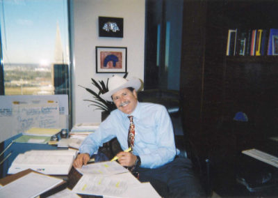 Old photo of Lee working at his desk.