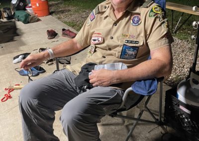Lee at a campout sitting in a camp chair